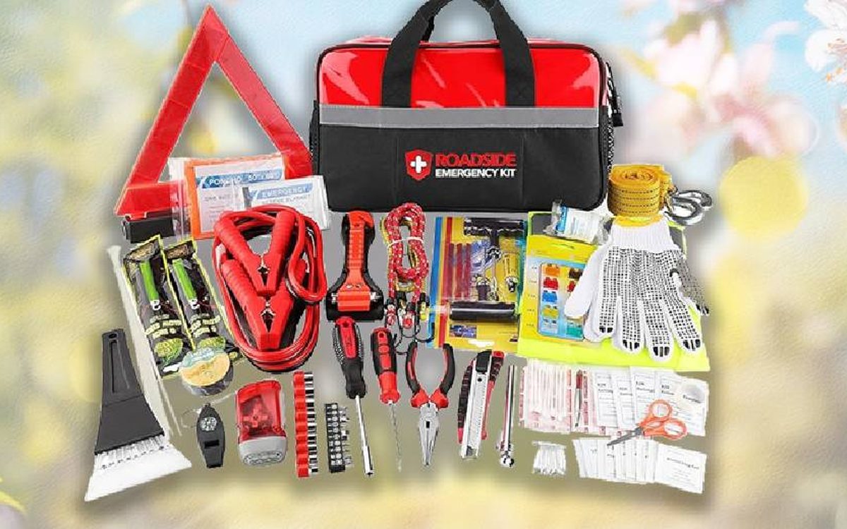 Roadside emergency kit with jumper cables, warning triangle, gloves and tools